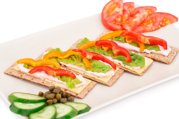 Crackers with fresh vegetables and cream