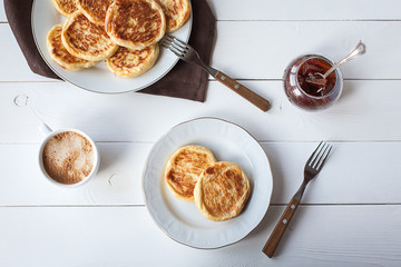 breakfast with cheese pancakes, coffee and jam