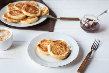 breakfast with cheese pancakes, coffee and jam