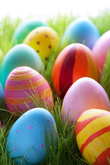Many Colorful Easter Eggs On Sunny Green Grass