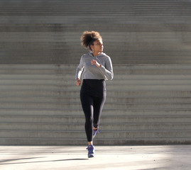 Young african american woman jogging alone outdoors