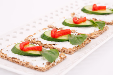 Fototapeta na wymiar Cracker with fresh vegetables and cream
