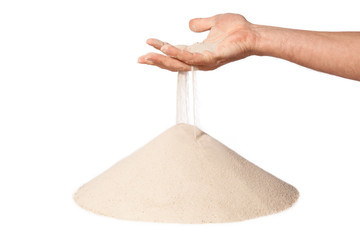 hand with falling sand on pile