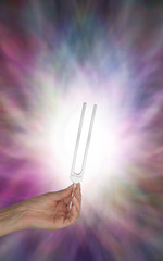 Holding Tuning Fork in Resonating Energy Field