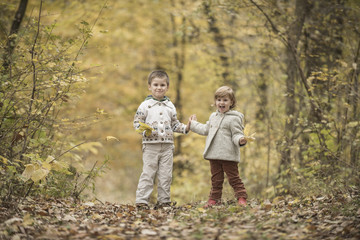 Fototapeta premium Children playing in a forest
