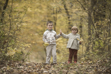 Fototapeta premium Children playing in a forest