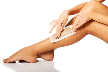 Woman waxing her leg