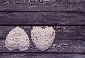 Two White hearts on aged wooden background