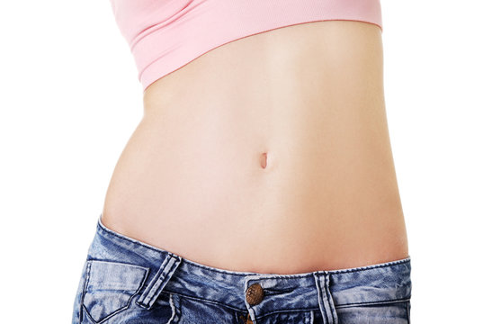 Closeup on fitness woman showing flat belly