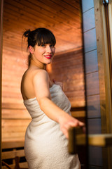 Fototapeta premium Young woman relaxing in a sauna