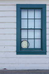 Old Clock behind Window