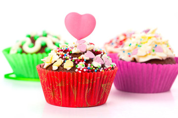 cupcakes with cream frosting and a red heart