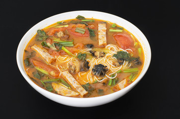Vietnamese Snail noodle soup, Bun Oc against black background