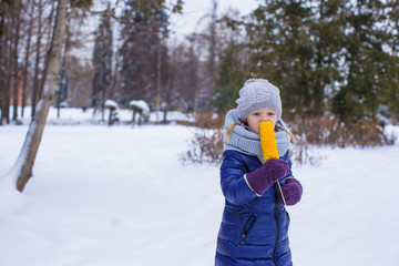 Little girl with sweet corn at winter park