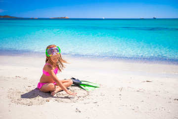 Little girl with flippers and goggles for snorkling