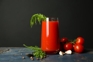 Glass of tasty tomato juice and fresh tomatoes