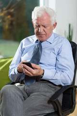 Senior businessman using phone