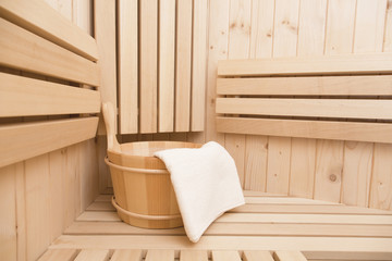 Fototapeta na wymiar Detail of bucket and white towels in a sauna