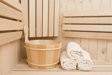 Obraz na płótnie Canvas Detail of bucket and white towels in a sauna