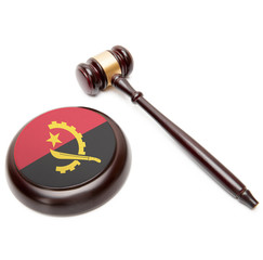 Judge gavel and soundboard with national flag on it - Angola