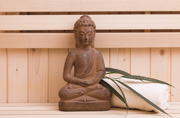 buddha statue and spa items in sauna, relaxation background