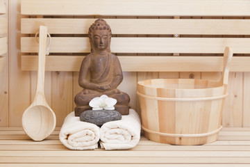 Fototapeta na wymiar buddha statue and spa items in sauna, relaxation background