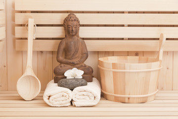 buddha statue and spa items in sauna, relaxation background