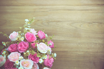 Rose flower bouquet on wooden backdrop