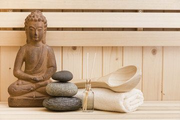 buddha statue and spa items in sauna, relaxation background