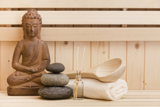 buddha statue and spa items in sauna, relaxation background