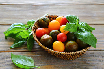 Fresh tomatoes with basil in a wicker basket