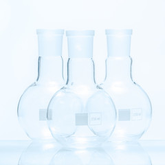 Set of three empty spherical flat bottomed temperature resistant