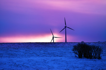 wind driven electric plant in firstlight in winter