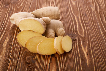 Ginger root sliced on wooden table