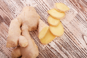 Ginger root sliced on wooden table