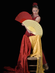 Obraz premium Women, dressed in flamenco, with two hand-held fans