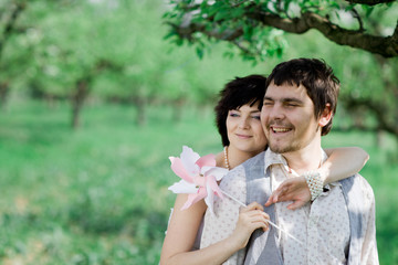 Fototapeta premium Young tenderness couple relax in blossoming garden