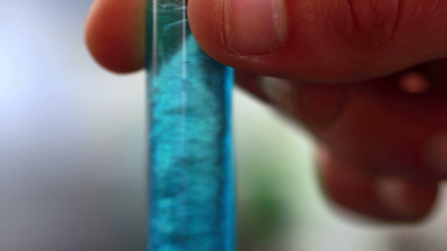 Scientist mixing test tube with centrifuge