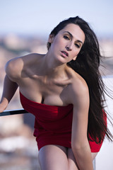 Fototapeta na wymiar Portrait of a beautiful woman posing with a red dress