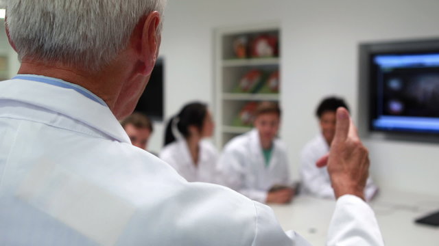 Medical professor teaching young students