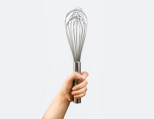 hand holding a whisk