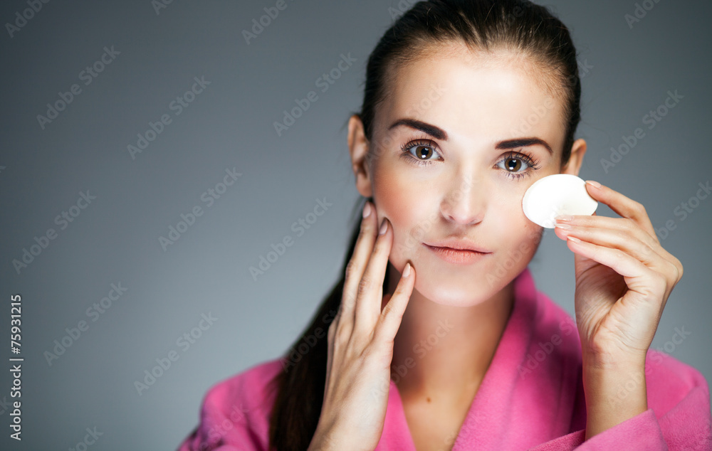 Sticker Fresh girl cleaning face with cotton swab