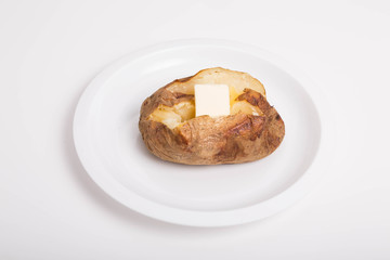 Hot Buttered Baked Potato on White Plate and Background