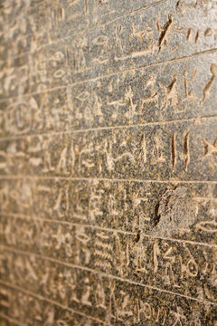 Egyptian hieroglyphics on stone relief close up