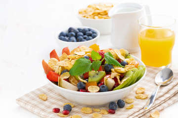 breakfast with fruit and berry salad, juice and cereal, close-up