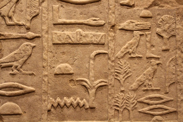 Egyptian hieroglyphics on stone relief close up
