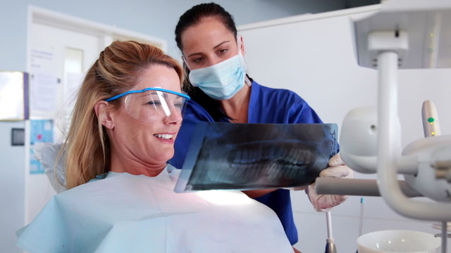 Dentist and patient looking at x-ray together