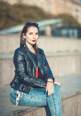 Young fashion beautiful girl in leather jacket and sunglasses