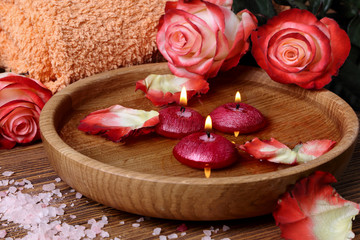 Spa concept with roses, pink salt and candles that float in wate