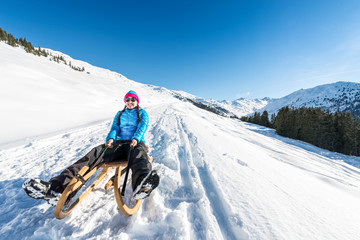 Young woman smiling on a sledge